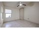 Bright bedroom with a ceiling fan, window, closet, and tile floors at 3727 N Kings Peak N Cir, Mesa, AZ 85215