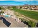 Aerial landscape showing a golf course view along with the homes in the community at 3727 N Kings Peak N Cir, Mesa, AZ 85215