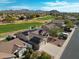 Scenic overhead front shot of a lovely desert home featuring solar panels, 2-car garage, and lush green landscaping at 3727 N Kings Peak N Cir, Mesa, AZ 85215