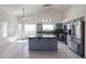 Modern kitchen with stainless steel appliances, granite countertops, and a center island at 3727 N Kings Peak N Cir, Mesa, AZ 85215