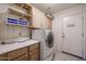 Functional laundry room with storage cabinets and a modern washer at 3727 N Kings Peak N Cir, Mesa, AZ 85215