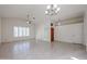 Spacious living room with tile flooring, bright lighting, and a modern ceiling fan at 3727 N Kings Peak N Cir, Mesa, AZ 85215