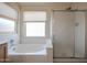 Bright bathroom with a large tub, separate shower, and a window with privacy blinds at 3727 N Kings Peak N Cir, Mesa, AZ 85215