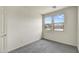 Bright bedroom with gray carpet and two large windows at 37549 W San Clemente St, Maricopa, AZ 85138