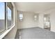 Well-lit bedroom with carpet, window, and bathroom access at 37549 W San Clemente St, Maricopa, AZ 85138