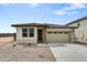 New single-story home with a two-car garage and stone accents at 37549 W San Clemente St, Maricopa, AZ 85138