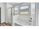 Bathroom with soaking tub, walk-in shower, and a window at 37551 W Patterson St, Maricopa, AZ 85138