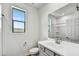 Modern bathroom with gray vanity and large mirror at 37551 W Patterson St, Maricopa, AZ 85138