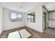 Bright dining area with wood-look flooring and large windows at 37551 W Patterson St, Maricopa, AZ 85138