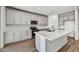 Modern kitchen with white cabinets and large island at 37551 W Patterson St, Maricopa, AZ 85138