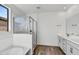 Bathroom with soaking tub, glass shower, and double vanity at 37566 W San Clemente St, Maricopa, AZ 85138