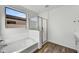 Modern bathroom with soaking tub, glass shower, and double vanity at 37566 W San Clemente St, Maricopa, AZ 85138