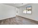 Bright bedroom with wood-look floors and large window at 37566 W San Clemente St, Maricopa, AZ 85138