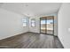 Bedroom with wood-look floors and sliding glass door to backyard at 37566 W San Clemente St, Maricopa, AZ 85138