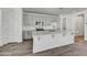 Modern kitchen featuring gray cabinets, white countertops, and stainless steel appliances at 37566 W San Clemente St, Maricopa, AZ 85138