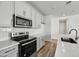 Modern kitchen with gray cabinets, white quartz countertops and stainless steel appliances at 37566 W San Clemente St, Maricopa, AZ 85138