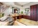 Elegant bathroom with dual sinks, rich wood cabinetry, and stone details at 39863 N 105Th Pl, Scottsdale, AZ 85262