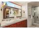 Elegant bathroom with double vanity and walk-in shower at 39863 N 105Th Pl, Scottsdale, AZ 85262