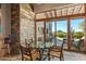 Breakfast nook with glass table and chairs, offering scenic views at 39863 N 105Th Pl, Scottsdale, AZ 85262