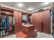 Large walk-in closet with ample storage space and custom shelving at 39863 N 105Th Pl, Scottsdale, AZ 85262