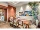 Elegant dining room with large wooden table and statement art at 39863 N 105Th Pl, Scottsdale, AZ 85262