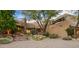 Front view of a stunning desert home with mature trees at 39863 N 105Th Pl, Scottsdale, AZ 85262