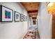 Long hallway with southwestern art and rustic flooring at 39863 N 105Th Pl, Scottsdale, AZ 85262