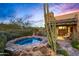 Relaxing hot tub nestled in a stone enclosure, desert landscape backdrop at 39863 N 105Th Pl, Scottsdale, AZ 85262