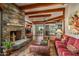 Living room featuring a stone fireplace and hardwood floors at 39863 N 105Th Pl, Scottsdale, AZ 85262