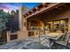 Outdoor kitchen with built-in grill and dining area at 39863 N 105Th Pl, Scottsdale, AZ 85262