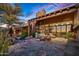 Relaxing patio features a stone fireplace and comfortable seating at 39863 N 105Th Pl, Scottsdale, AZ 85262