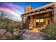 Peaceful stone patio with seating area, offering sunset views at 39863 N 105Th Pl, Scottsdale, AZ 85262