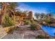 Stunning pool and patio area with a stone pathway and desert landscaping at 39863 N 105Th Pl, Scottsdale, AZ 85262