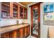 Wet bar with wine storage and custom cabinetry at 39863 N 105Th Pl, Scottsdale, AZ 85262