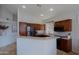 Spacious kitchen with dark wood cabinets, stainless steel appliances, and a breakfast bar at 4119 E Barwick Dr, Cave Creek, AZ 85331