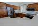 Modern kitchen featuring dark wood cabinets and stainless steel appliances at 4119 E Barwick Dr, Cave Creek, AZ 85331