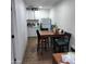 Simple kitchen with white cabinets and a dining table at 4131 N 55Th Dr, Phoenix, AZ 85031