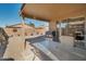 Covered patio with seating area and a built-in grill at 43568 W Bedford Dr, Maricopa, AZ 85138