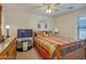 Cozy bedroom with wood furniture and ceiling fan at 43568 W Bedford Dr, Maricopa, AZ 85138