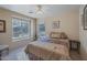 Bedroom with window seat and ceiling fan at 43568 W Bedford Dr, Maricopa, AZ 85138