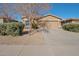 Single story home with a two car garage and desert landscaping at 43568 W Bedford Dr, Maricopa, AZ 85138