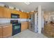 Bright kitchen with stainless steel appliances and wood cabinets at 43568 W Bedford Dr, Maricopa, AZ 85138