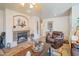 Comfortable living room with a fireplace and hardwood floors at 43568 W Bedford Dr, Maricopa, AZ 85138