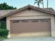 Attached garage with decorative windows and neutral color scheme at 437 E Marconi Ave, Phoenix, AZ 85022