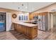 Modern kitchen with stainless steel appliances and wood cabinets at 437 E Marconi Ave, Phoenix, AZ 85022