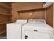 Laundry room with washer, dryer and extra shelving at 437 E Marconi Ave, Phoenix, AZ 85022