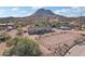 Aerial view of a ranch-style home with a corral, mountain backdrop, and ample parking at 47435 N Meander Rd, New River, AZ 85087