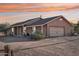 House exterior showcasing a single-story home with attached garage and desert landscaping at 47435 N Meander Rd, New River, AZ 85087