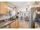 Kitchen with copper sink, granite counters, and view into dining area at 47435 N Meander Rd, New River, AZ 85087