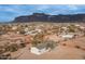 Aerial view showing a house in a desert area with mountains in the background at 5089 E 26Th Ave, Apache Junction, AZ 85119